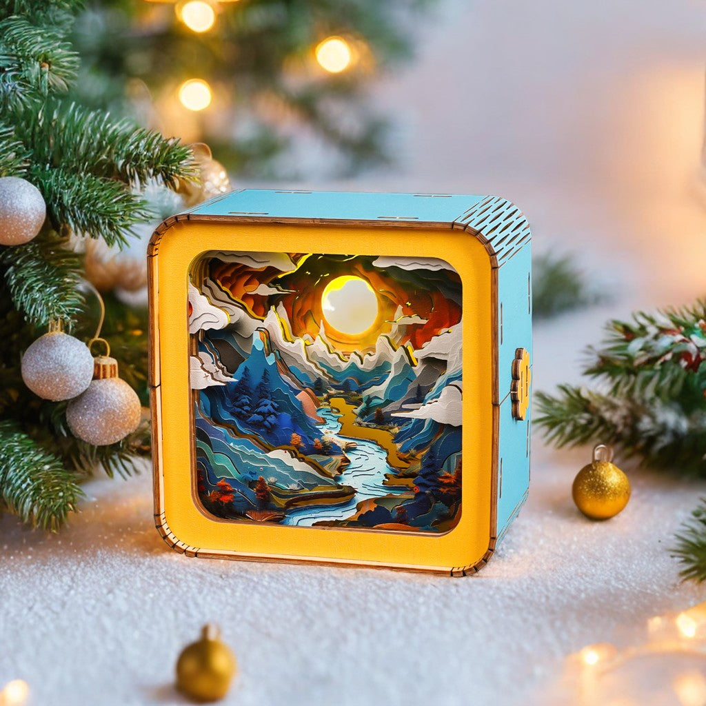 Moonlit Mountain Kit 3D wooden puzzle night light surrounded by festive greenery and ornaments.