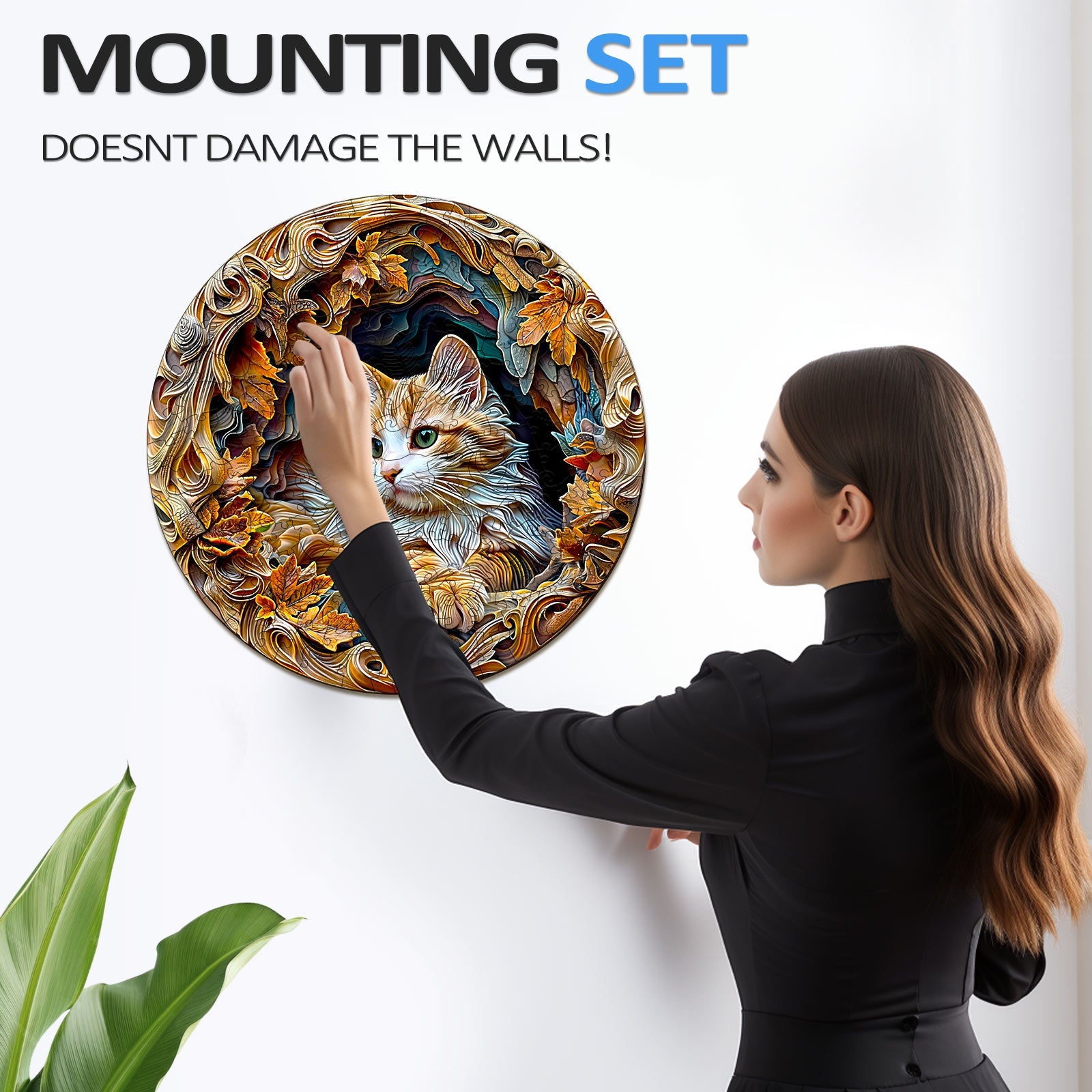 Woman using a mounting set to display a circular 3D cat puzzle on a wall without damage.