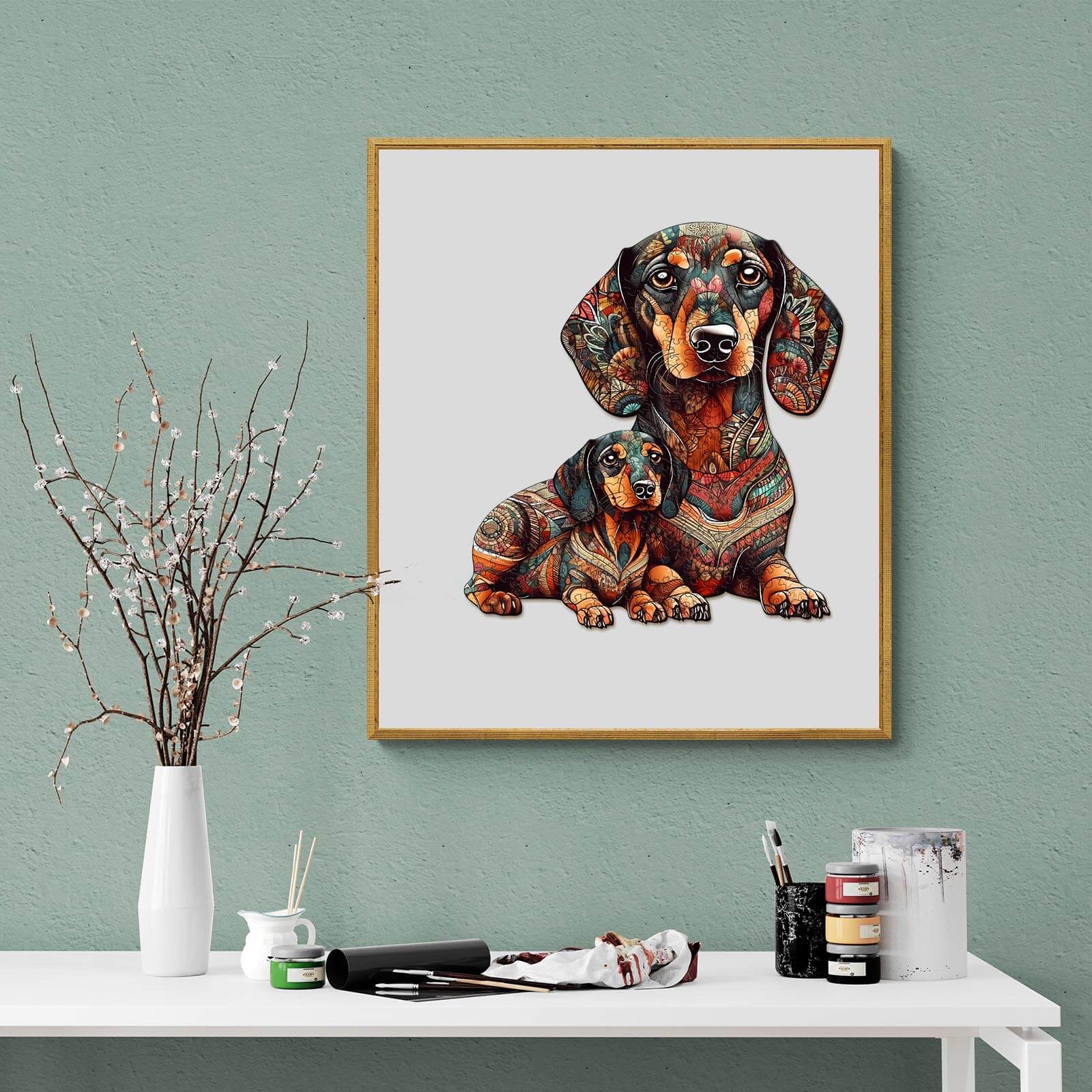 Colorful art print of two dachshunds in intricate designs, displayed on a stylish tabletop with decor.
