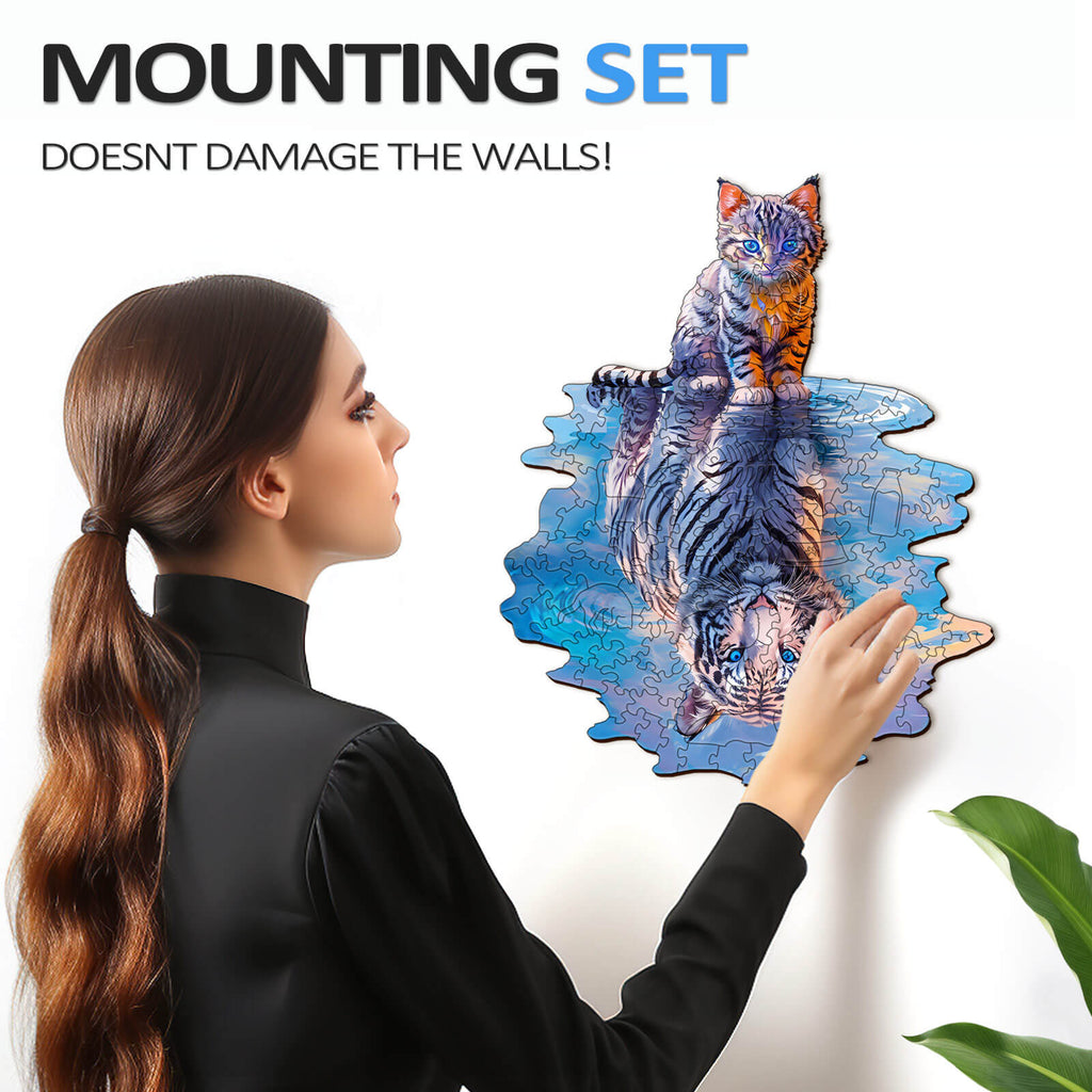 Woman hanging Cat Tiger Wooden Jigsaw Puzzle on wall with no damage, featuring beautifully designed tigers.