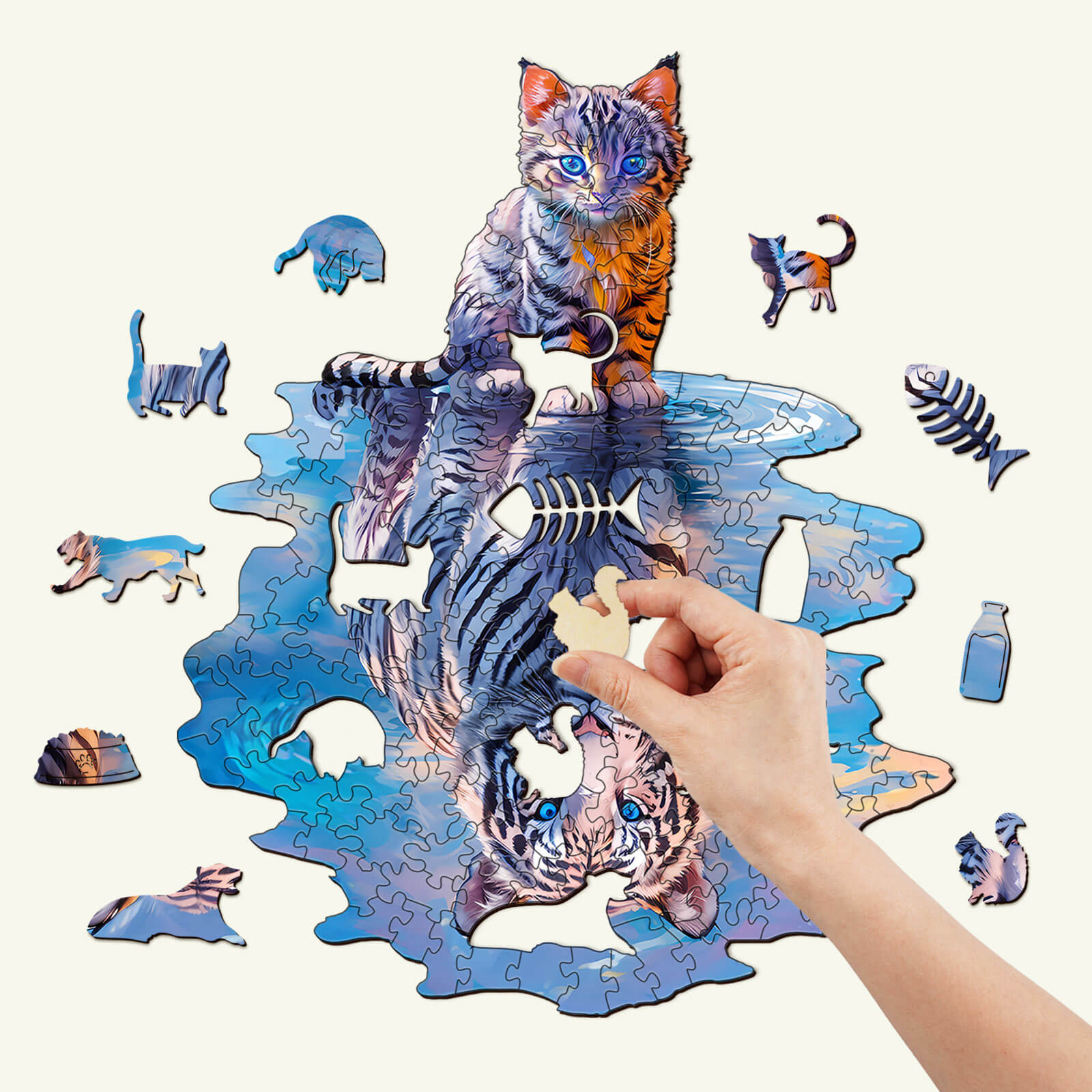 A hand placing a piece in the Cat Tiger wooden jigsaw puzzle, featuring a colorful cat and playful puzzle pieces.