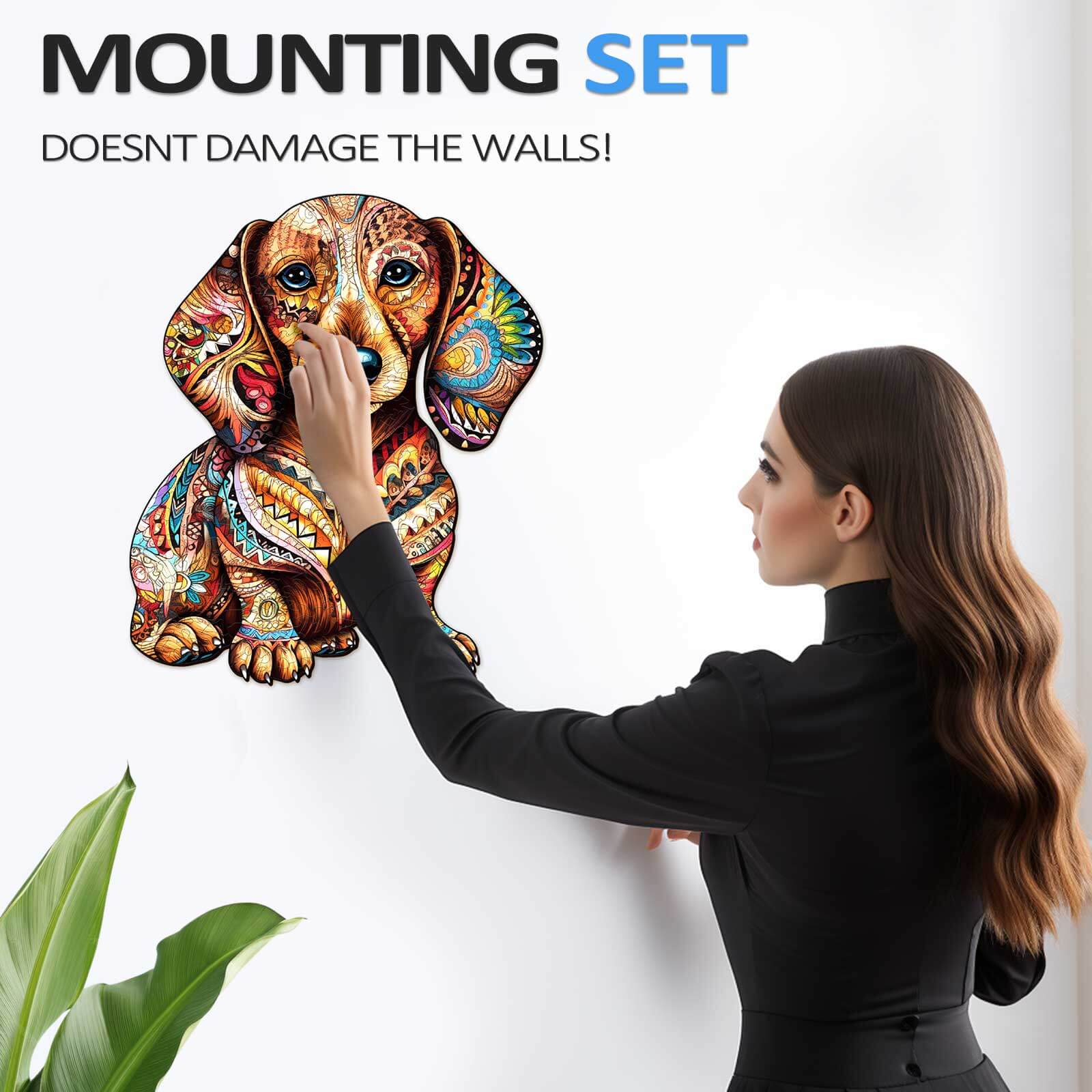 Woman installing colorful dachshund wall art using a mounting set that doesn't damage walls.