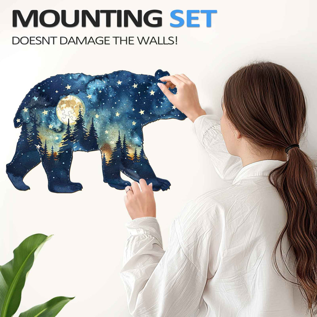 Person applying a celestial bear wall art using a mounting set that doesn't damage walls.