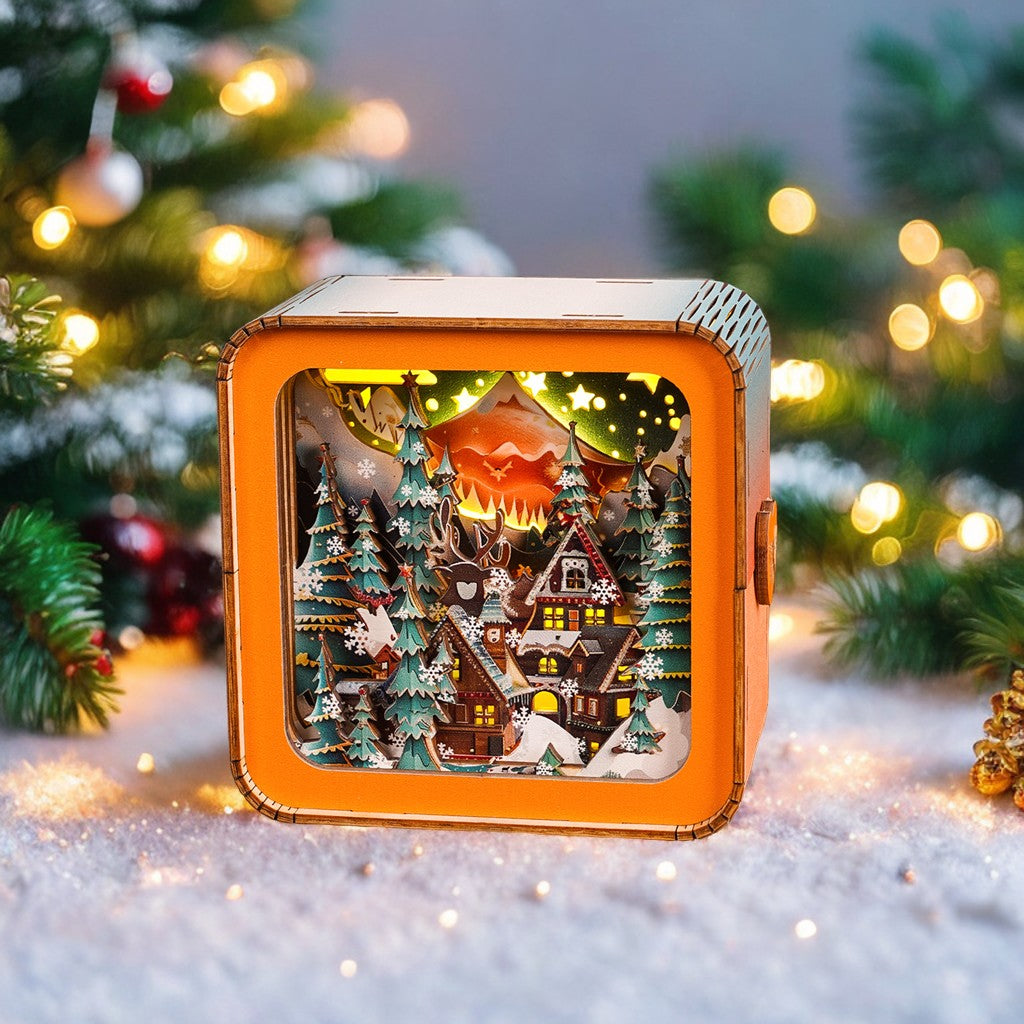3D wooden puzzle night light featuring a cozy winter scene with a cabin surrounded by snowy trees and mountains.