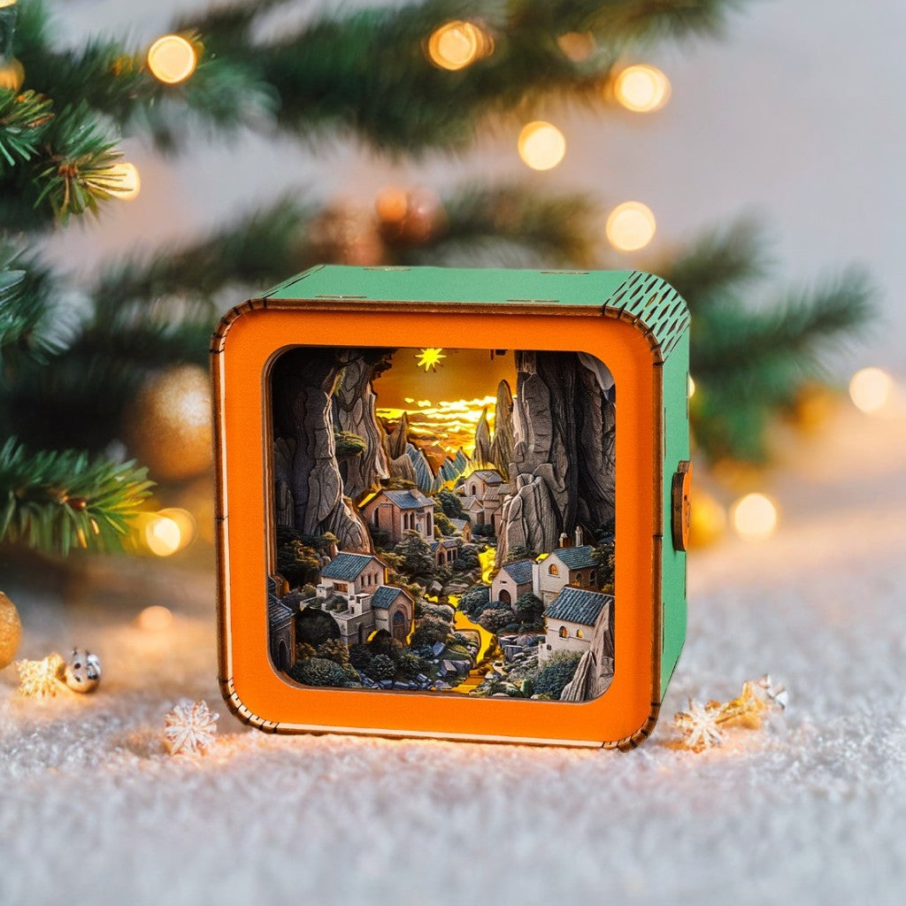 3D wooden puzzle night light displaying a scenic village landscape with warm lighting, surrounded by holiday decorations.